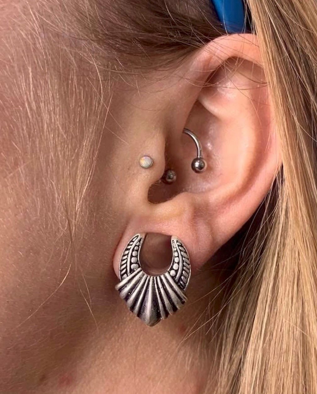 Conch and lobe piercings with decorative jewelry, San Diego