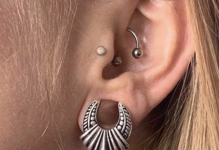 Conch and lobe piercings with decorative jewelry, San Diego