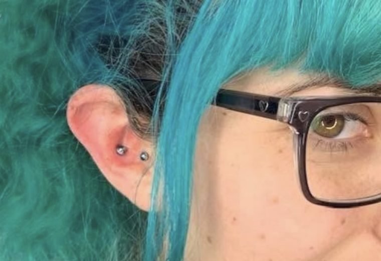 Healed ear piercings with gold jewelry at our San Diego piercing studio