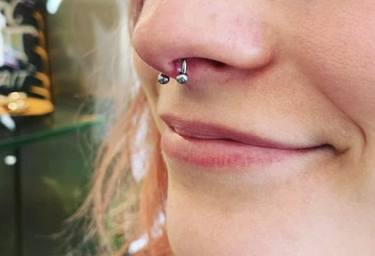 Nose piercing with hoop jewelry by San Diego Piercing Company